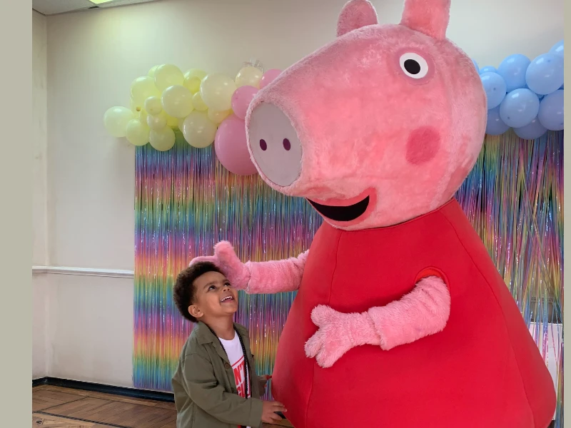 Peppa Pig with a child at the Peppa Pig flu clinic