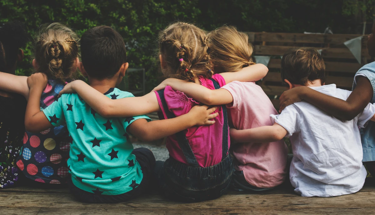 An image of children hugging each other